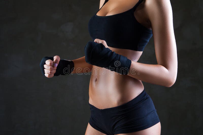 Beautiful fit woman model in black hand bandage