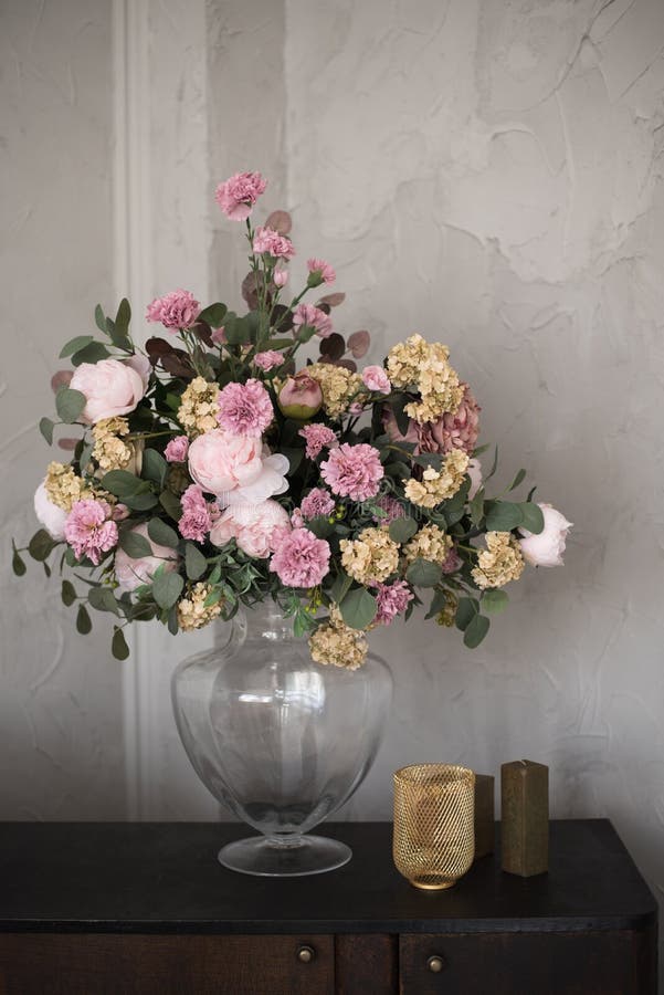 Beautiful flowers with books on brick wall background.