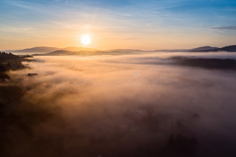 Beautiful foggy sunset in Polish mountains Silesian Beskid.