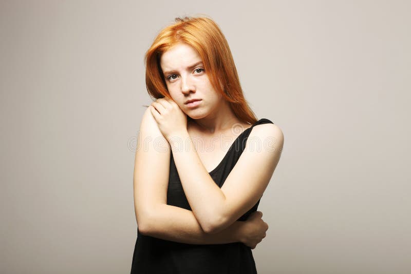 Young beautiful woman, attractive natural redhead, showing emotions, facial expressions, posing on isolated background.