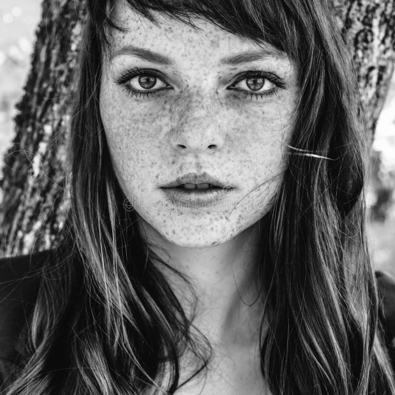 Beautiful freckle woman in autumn park black and white