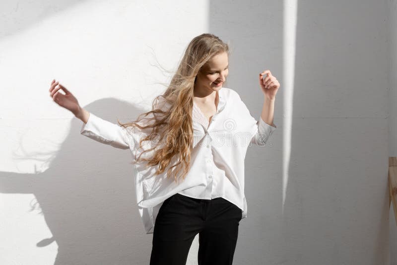 Beautiful fresh blonde model in white shirt and black trousers. stock image Beautiful fresh blonde model in white shirt and black trousers. stock image