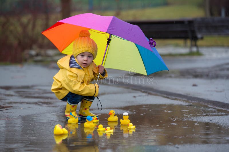Beautiful Funny Blonde Toddler Boy with Rubber Ducks and Colorful Umbrella, Jumping in Puddles and Playing in the Rain Stock Photo - Image of child, clothing: 186403814 Beautiful Funny Blonde Toddler Boy with Rubber Ducks and Colorful Umbrella, Jumping in Puddles and Playing in the Rain Stock Photo - Image of child, clothing: 186403814