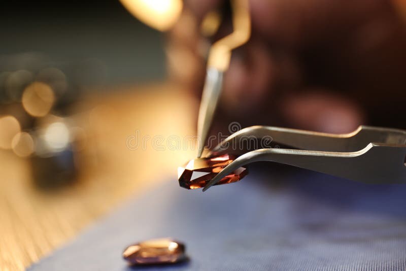Beautiful gemstone in jeweler`s workshop, closeup. Space for text