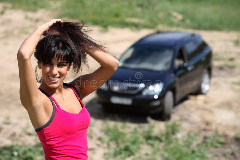 Beautiful girl on the background of his car