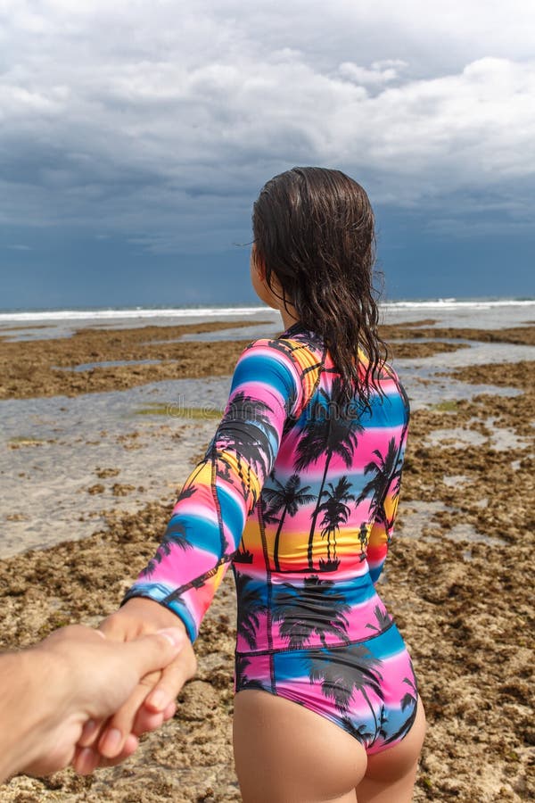 The girl leads by the hand on the beach royalty free stock photos The girl leads by the hand on the beach royalty free stock photos