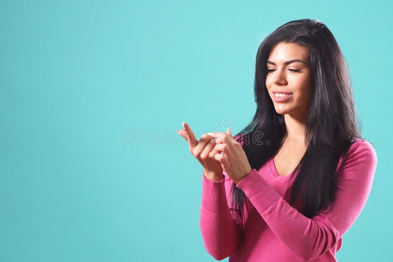 Beautiful girl with black hair makes a wish and bends her fingers on her hand stock image Beautiful girl with black hair makes a wish and bends her fingers on her hand stock image