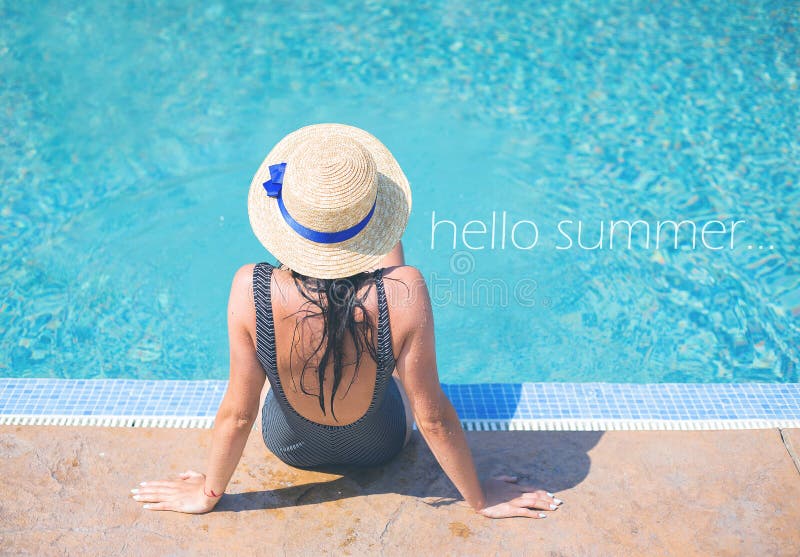 Beautiful girl in a black swimsuit near a blue pool-summer, sun, rest, inscription hello summer