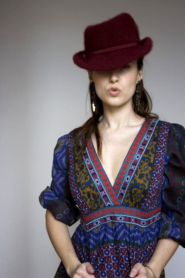 Beautiful girl in bohemian dress and red hat