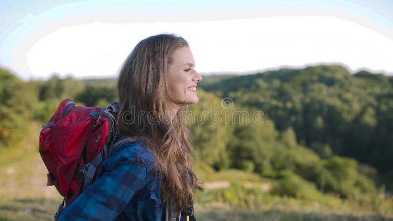 Beautiful girl traveling with bag, hiking in nature.
