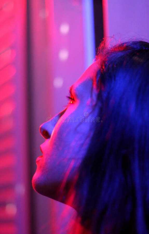 Beautiful girl close up in disco light