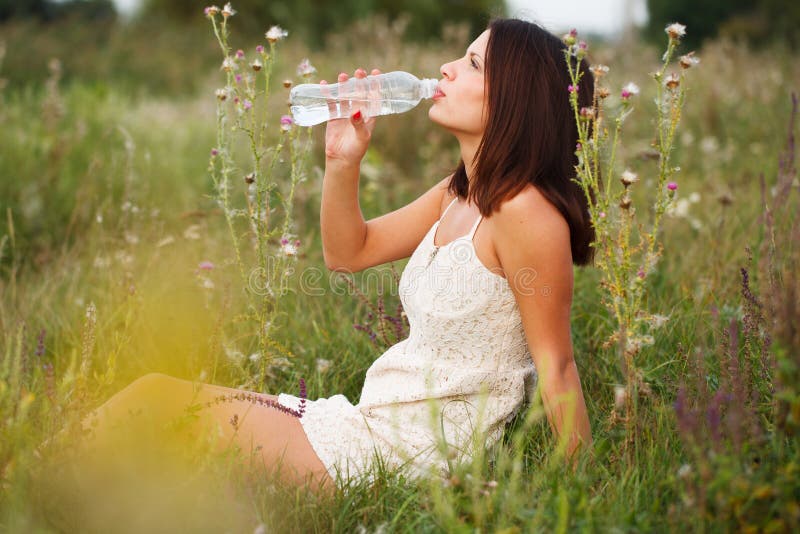 Beautiful girl drinking water