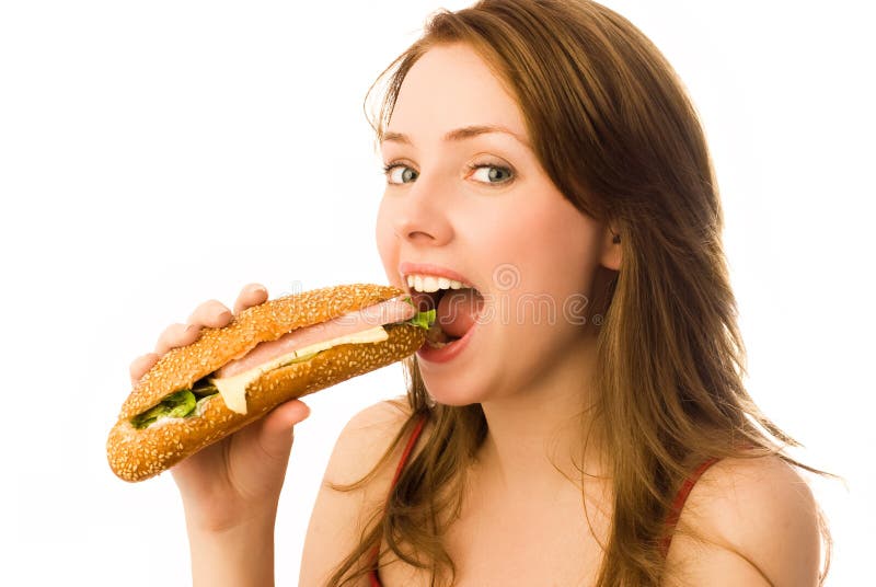 Beautiful girl eating a hot dog