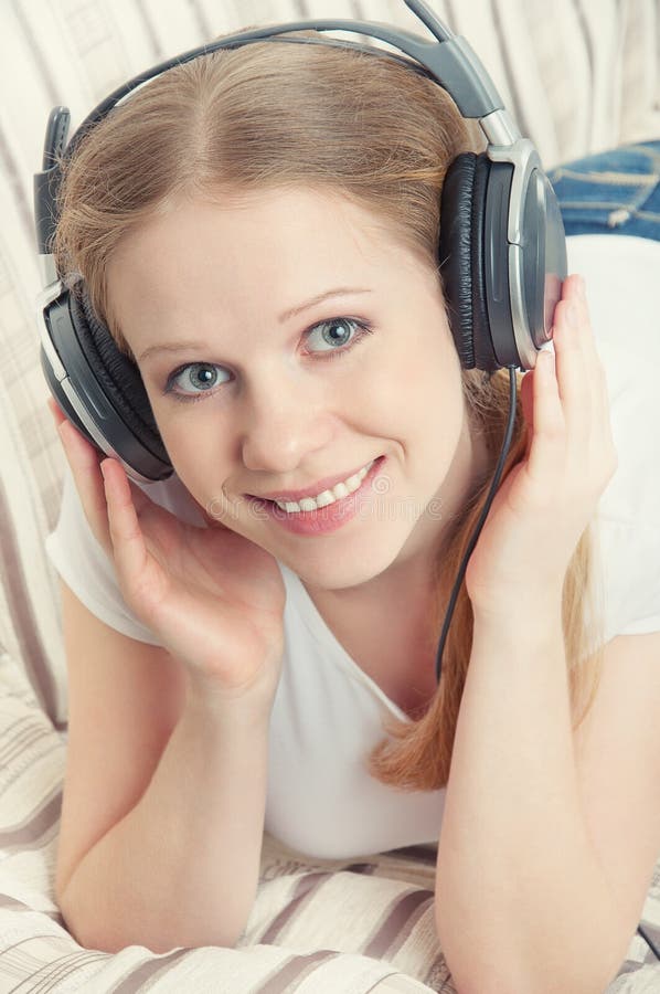 Beautiful girl enjoys listening to music