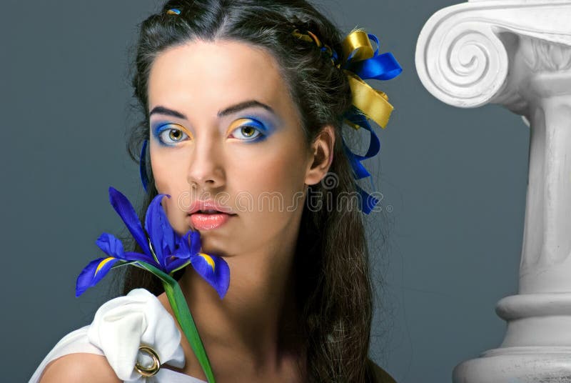 Beautiful girl with flowers in the image of an ancient goddess