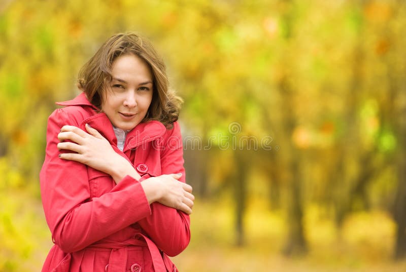 Beautiful girl freezing in autumn park