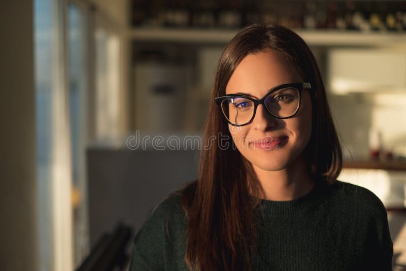 Beautiful girl with glasses smiling and standing by the window royalty free stock image Beautiful girl with glasses smiling and standing by the window royalty free stock image