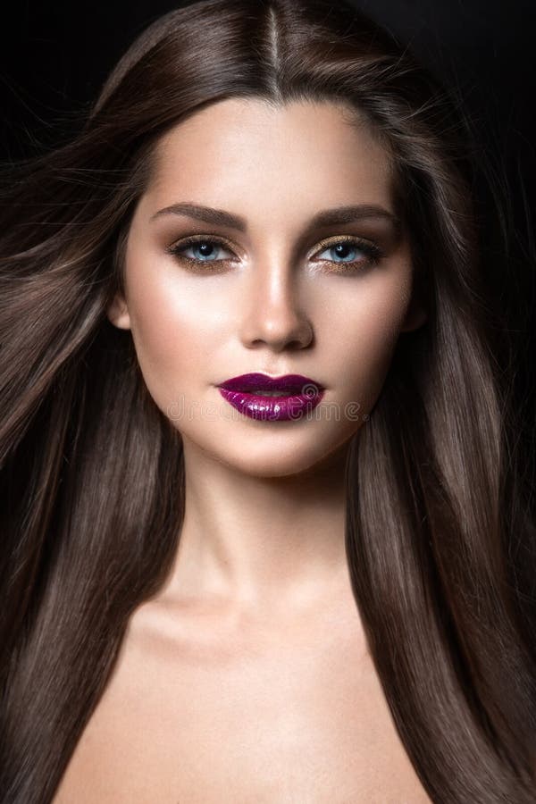 Beautiful Girl with Golden Makeup and Burgundy Lips with the Wind in ...