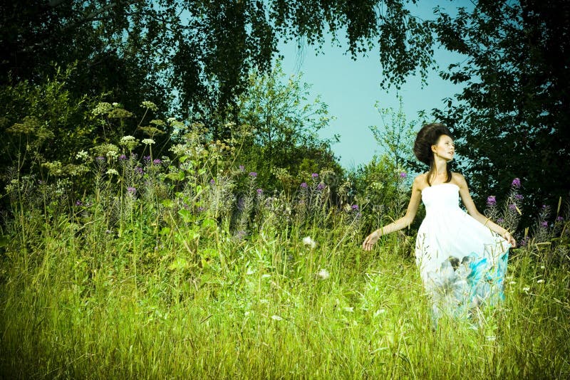 Beautiful girl in green meadow
