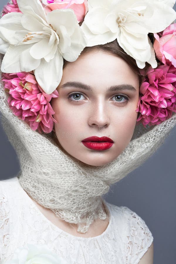 Beautiful girl in a headscarf in the Russian style, with large flowers on his head and red lips. Beauty face. stock images Beautiful girl in a headscarf in the Russian style, with large flowers on his head and red lips. Beauty face. stock images