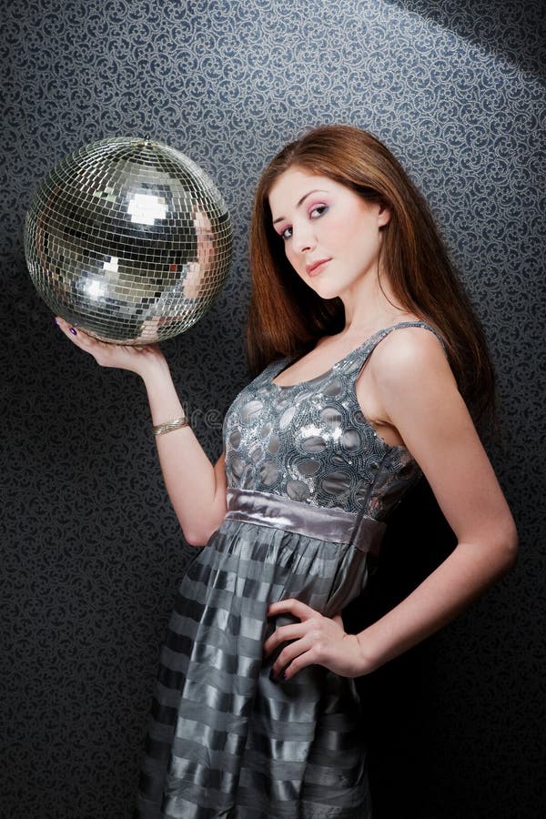 Beautiful girl holding disco ball.