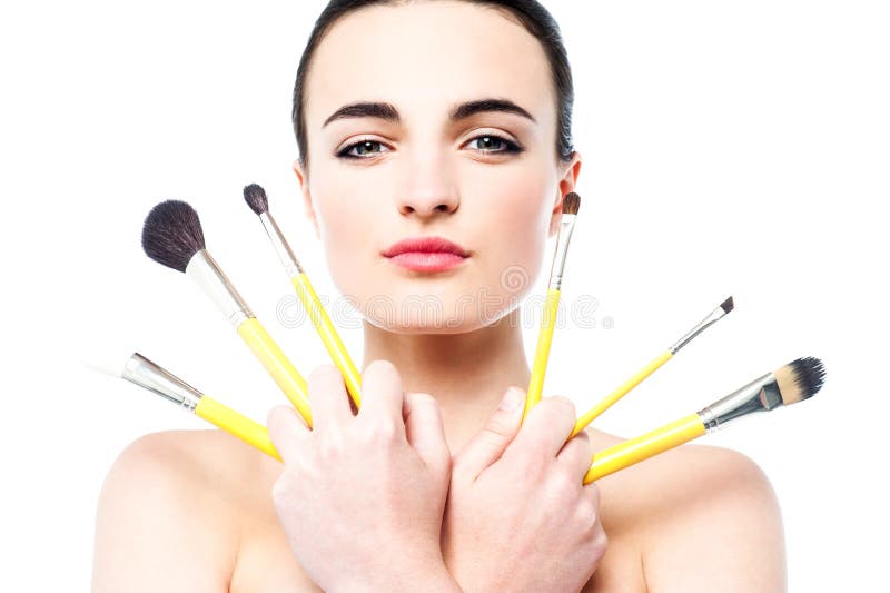 Beautiful teen girl holding makeup brushes Stock Photo by ©stockyimages  27657527