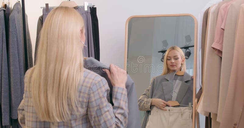 Beautiful Girl Looking in the Mirror and Trying on bra in dressing room  Stock Video Footage by ©LSFootage #265547038