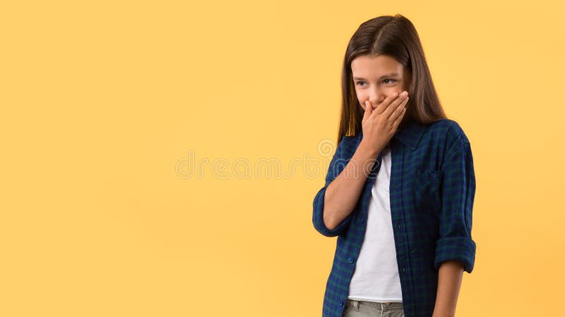 Beautiful girl laughing with hand over mouth