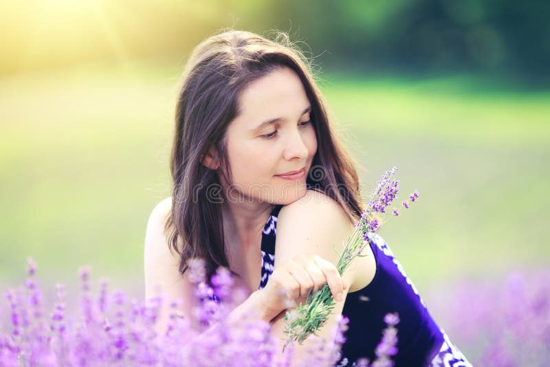 Beauty girl in lavender field. Happy woman on meadow backgrou