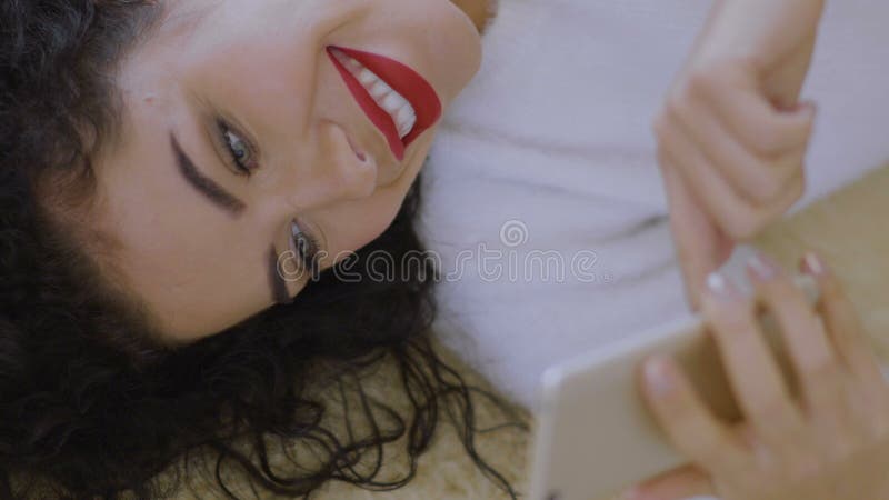 Beautiful girl with red lips use phone