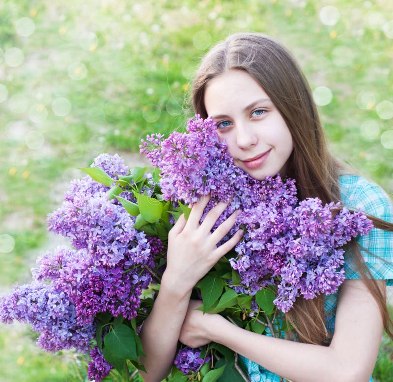 Beautiful girl with lilac flowers