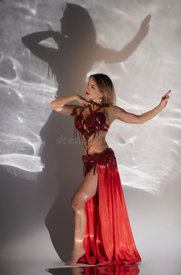 Beautiful Belly-dancer With Long Ginger Hair And Arabic Makeup, Isolated  Against Ight Blue Studio Background Stock Photo, Picture and Royalty Free  Image. Image 55420134.