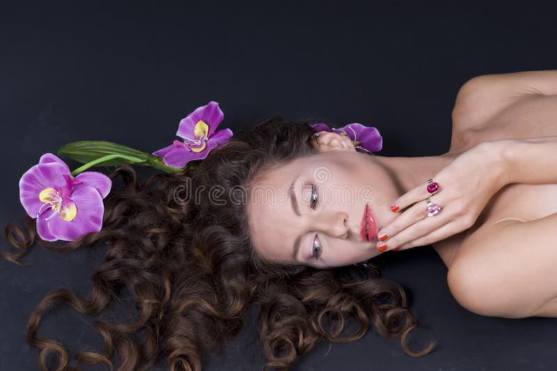 Beautiful girl with long wavy hair on the floor