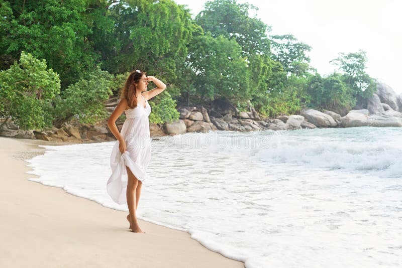 Beautiful girl looking far away being on the seacoast in Thailand.