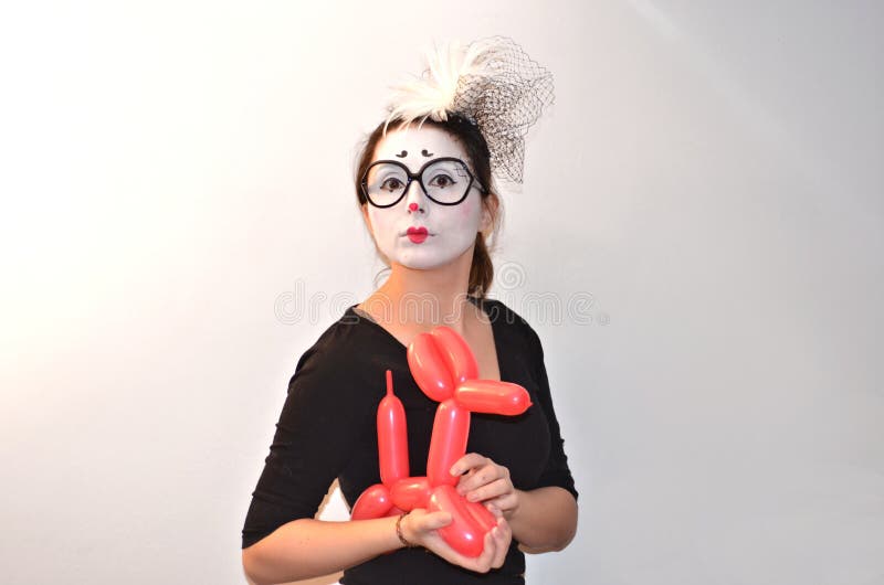 Beautiful girl-mime holding balloon dog. royalty free stock photos Beautiful girl-mime holding balloon dog. royalty free stock photos