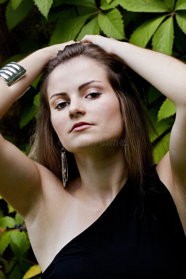 Beautiful Girl In Dark Leather Clothes Holding A Large Retro Radio 