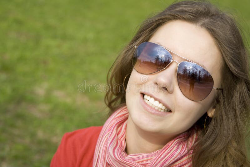 Beautiful girl in a park smiling.