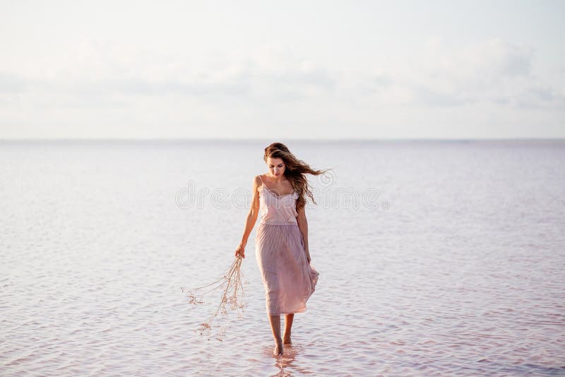 Beautiful girl on a pink lake. stock photos Beautiful girl on a pink lake. stock photos