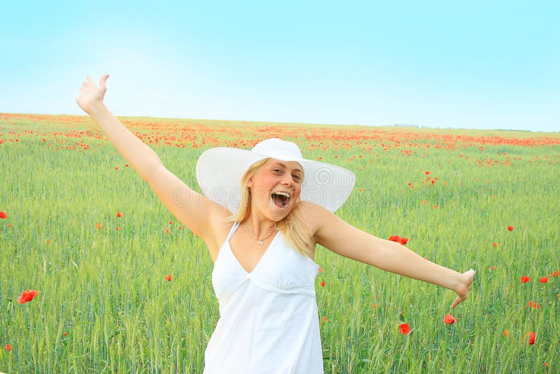 Beautiful girl in the poppy field