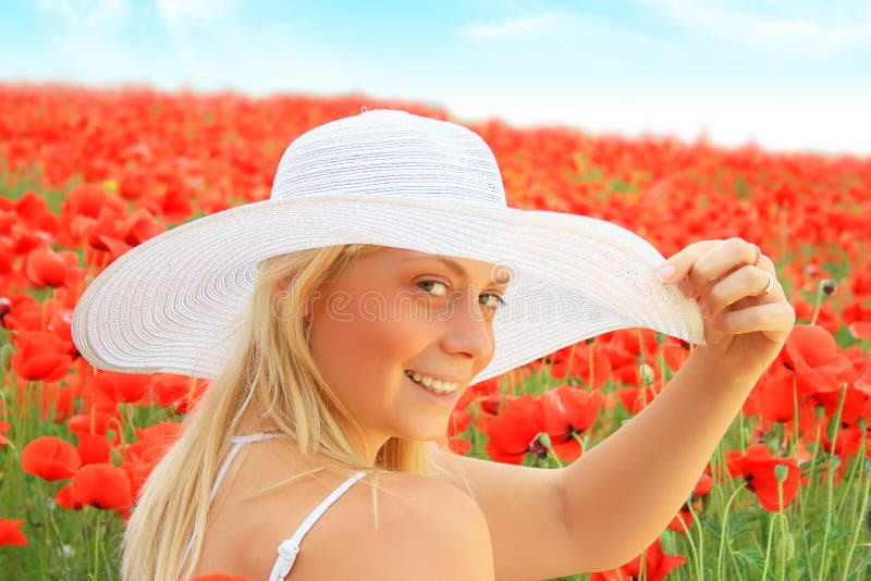 Beautiful girl in the poppy field