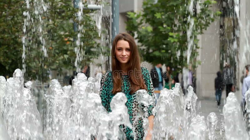 Beautiful girl posing in fountain.