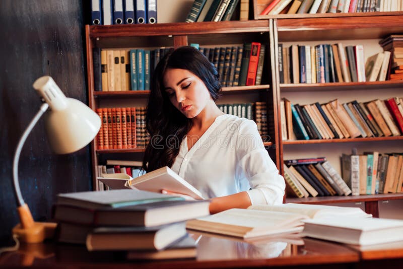 Girl is Preparing for the Exam Reading Book at the Library Stock Image