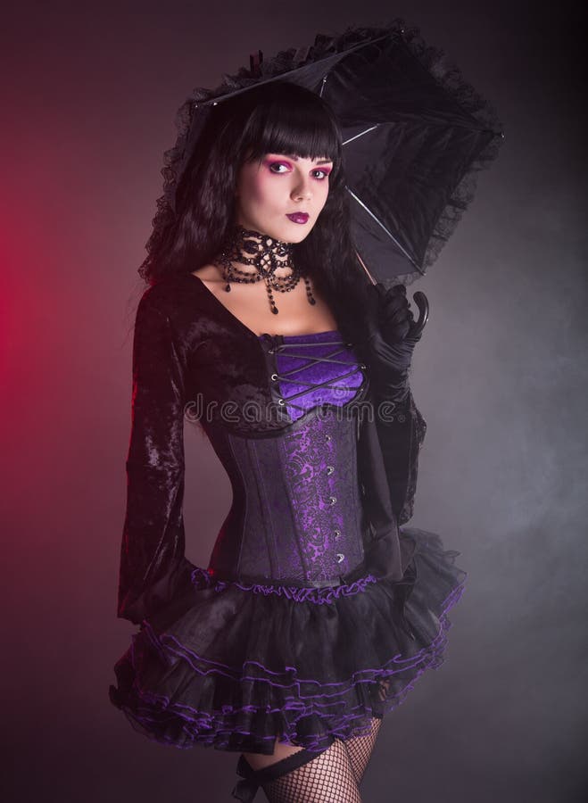Beautiful girl in purple and black gothic outfit