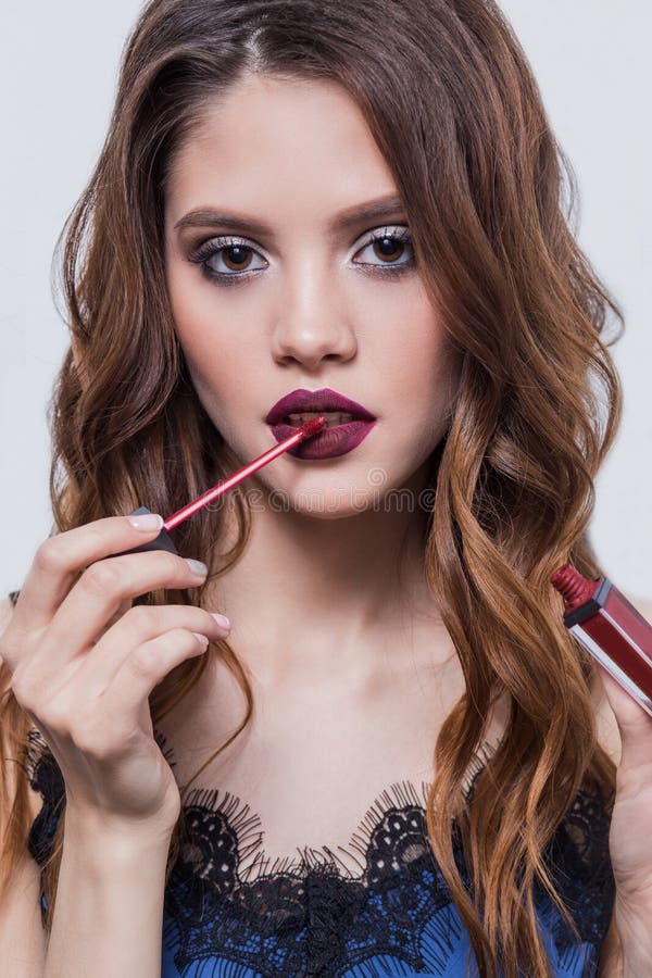 Beautiful Girl Puts On The Lips Lipstick Lip Gloss Close Up Stock Image Image Of Luxurious