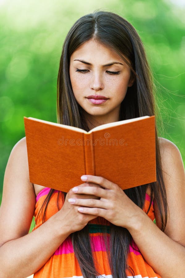 Beautiful girl reading book