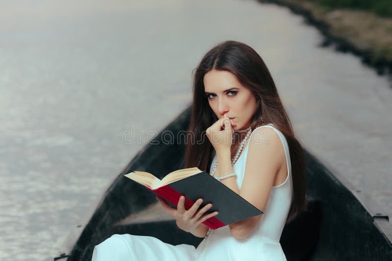 Retro Woman Reading a Book in a Vintage Boat stock photography