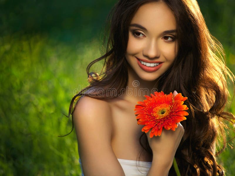 Beautiful Girl With Red Flowers. Beautiful Model Woman Face.