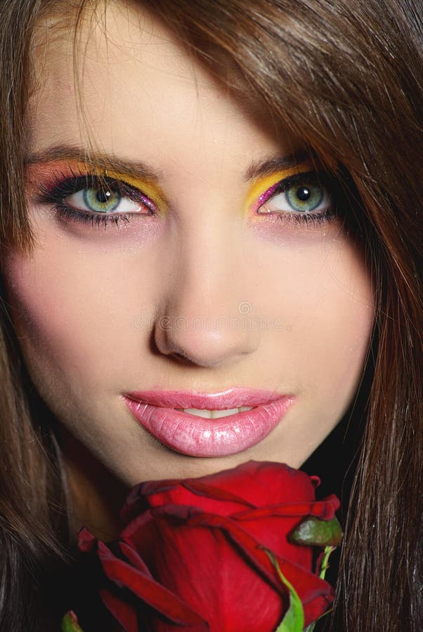 Beautiful girl with red rose