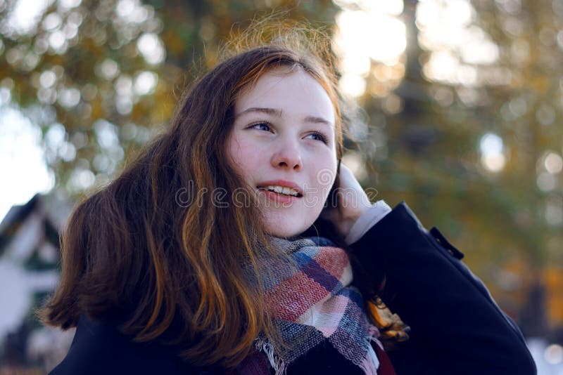 A Beautiful Girl with Reddish Hair Smiles Stock Photo - Image of branch ...