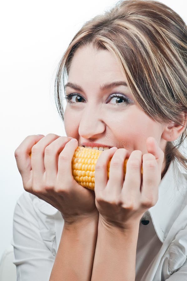 Beautiful girl s face eating corn vegetable